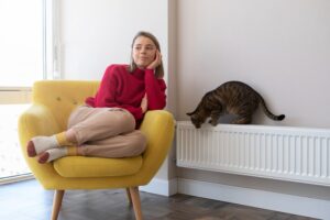 full shot woman sitting chair min